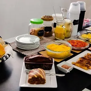 Na Praia Suítes Quarto em Acomodações Particulares